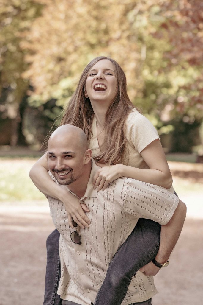 A couple is fooling around in Villa dei Cedri Park in Bellinzona, laughing