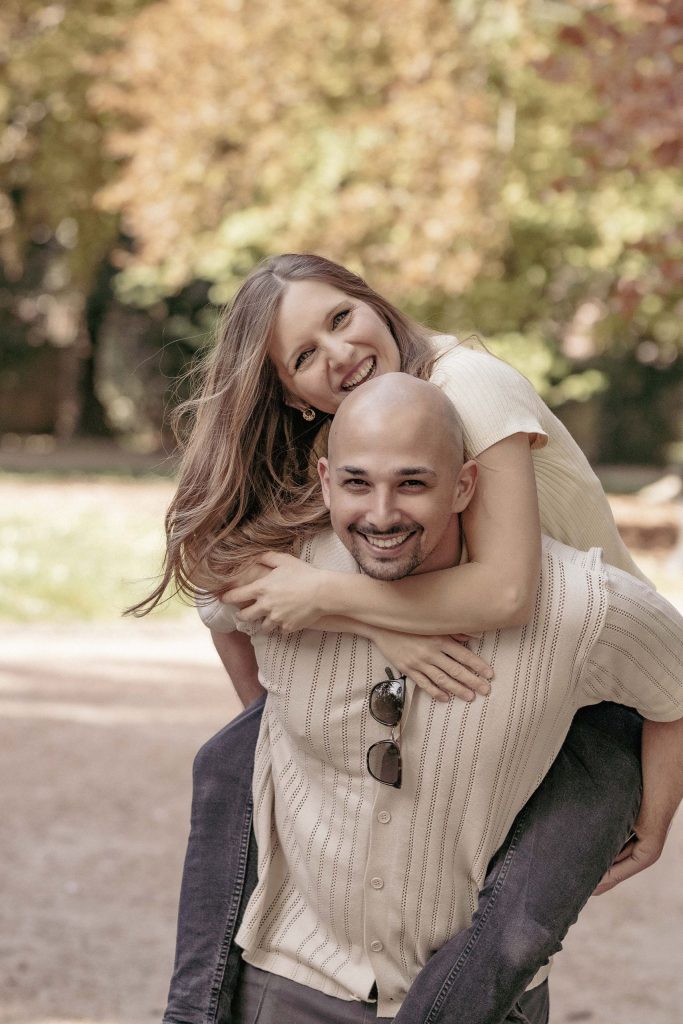A couple is fooling around in Villa dei Cedri Park in Bellinzona, laughing