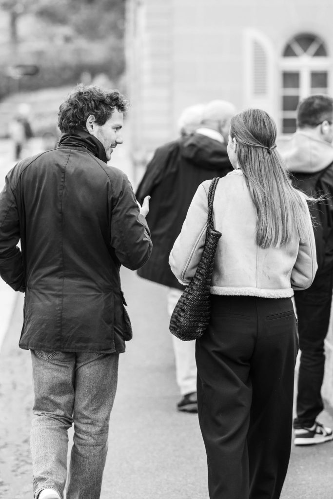 A couple is walking side by side through the city streets in Switzerland