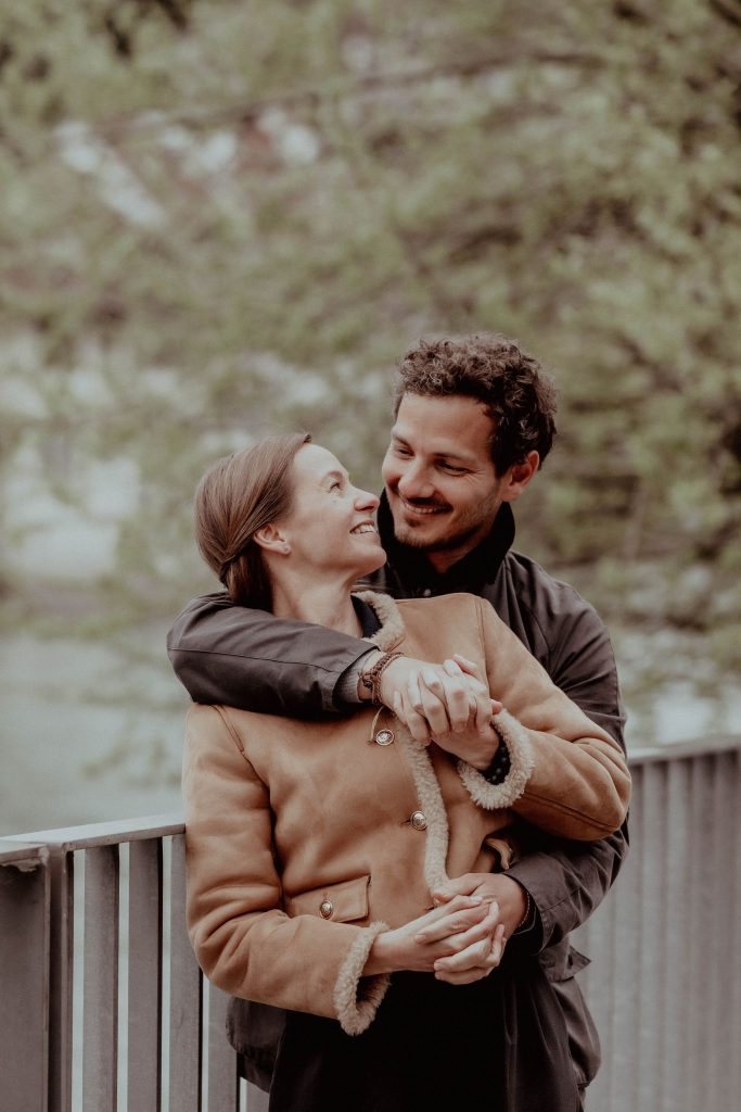 A couple is hugging each other on the city streets in Switzerland