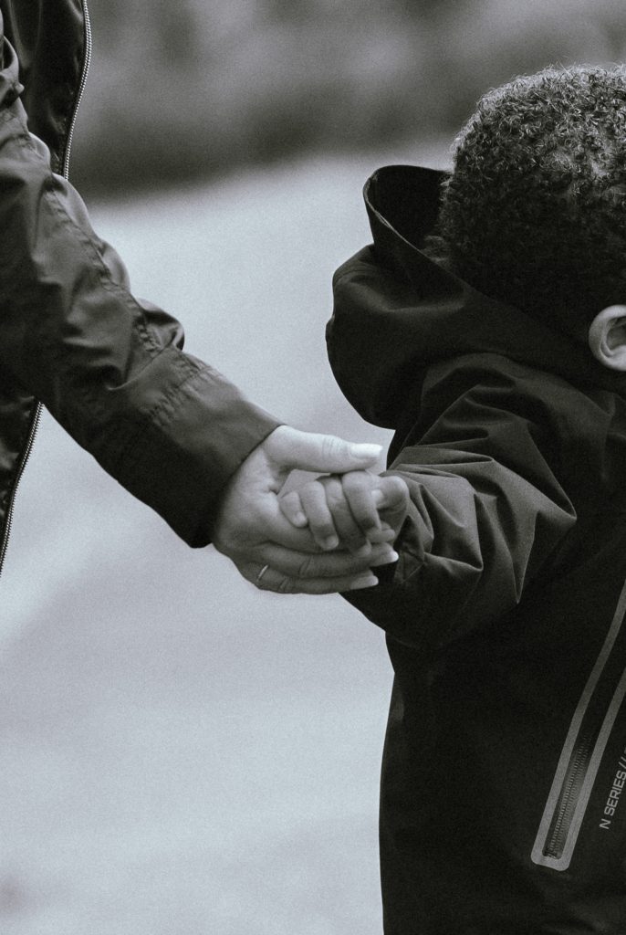 A mother is holding her little boy's hand in London