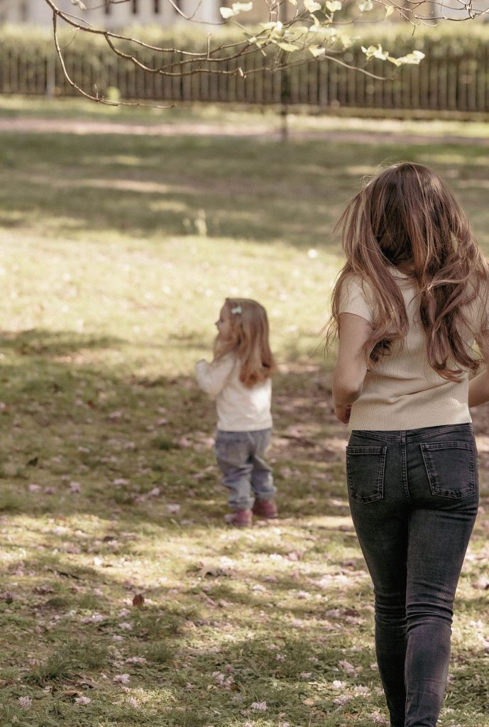 A mother runs toward her little girl in Villa dei Cedri Park in Bellinzona