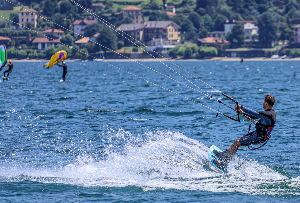 A man is kitesurfing on Lago di Como in Italy
