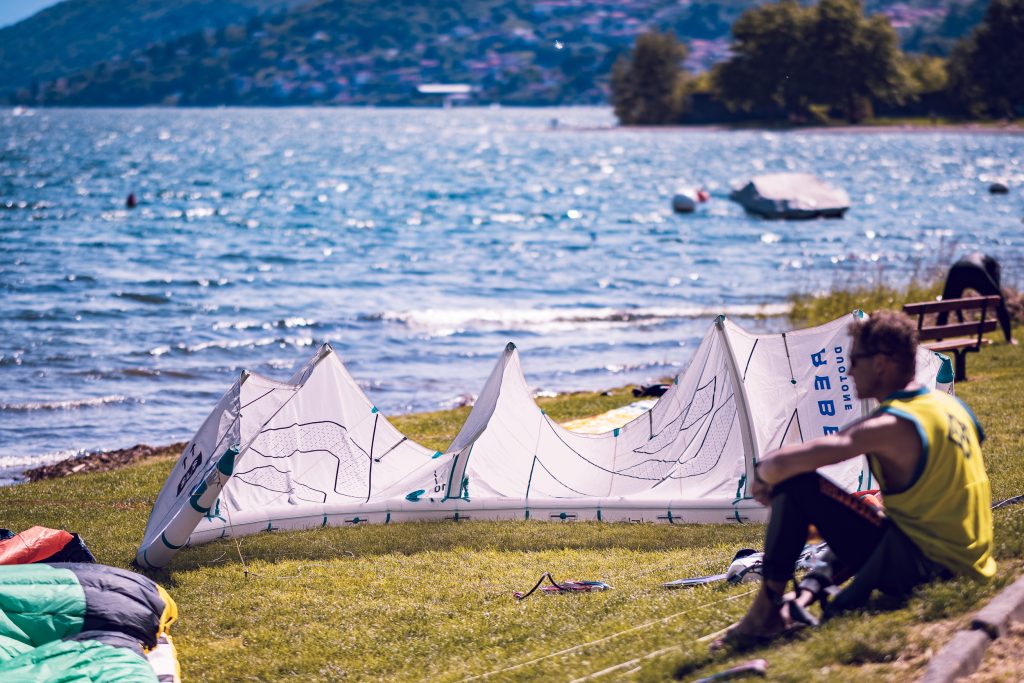 A man is sitting in the grass in Italy, at Lago di Como