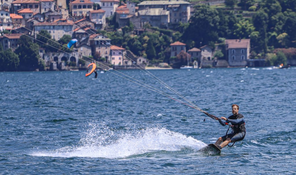 A man is kitesurfing on Lago di Como in Italy