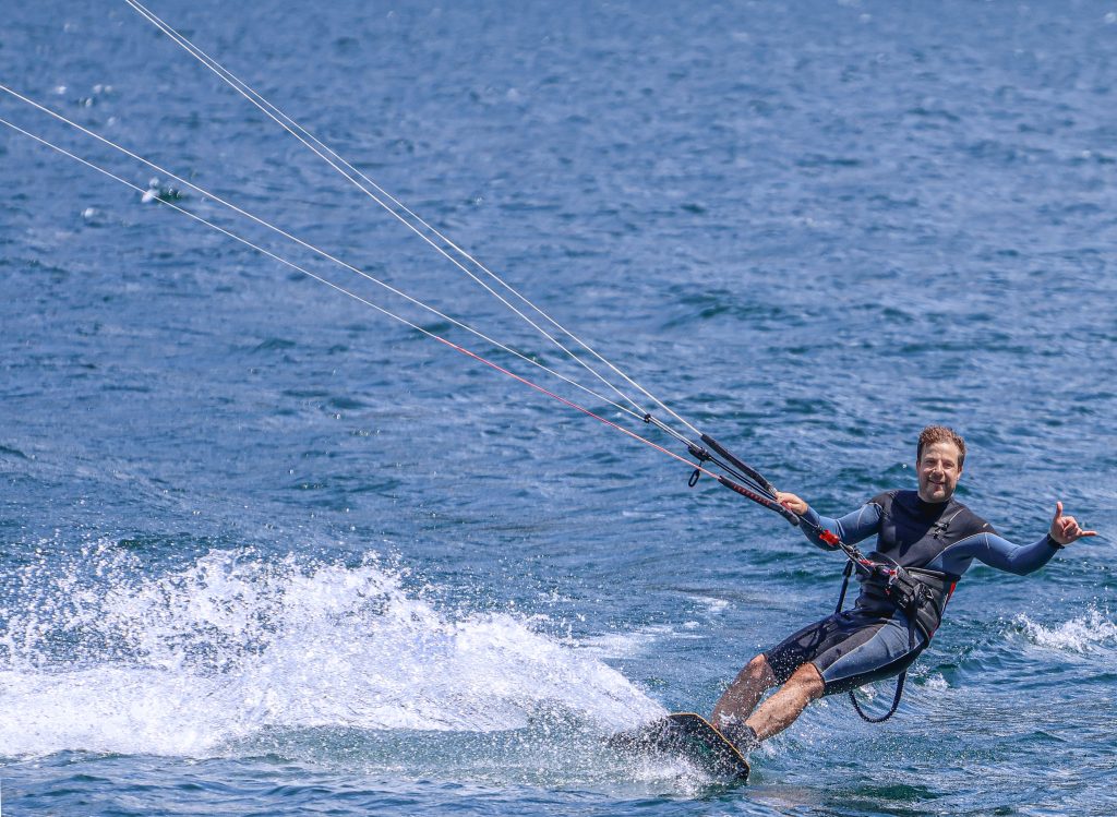 A man is kitesurfing on Lago di Como in Italy