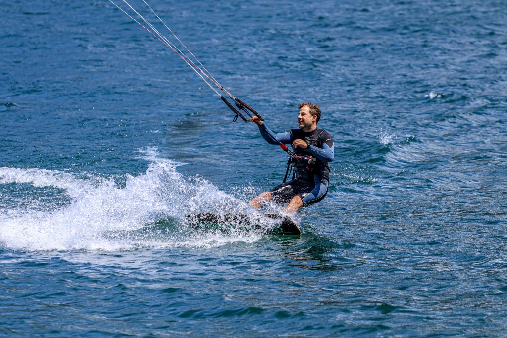 A man is kitesurfing on Lago di Como in Italy