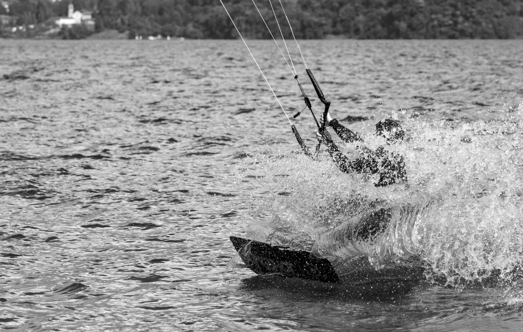 A man is kitesurfing on Lago di Como in Italy
