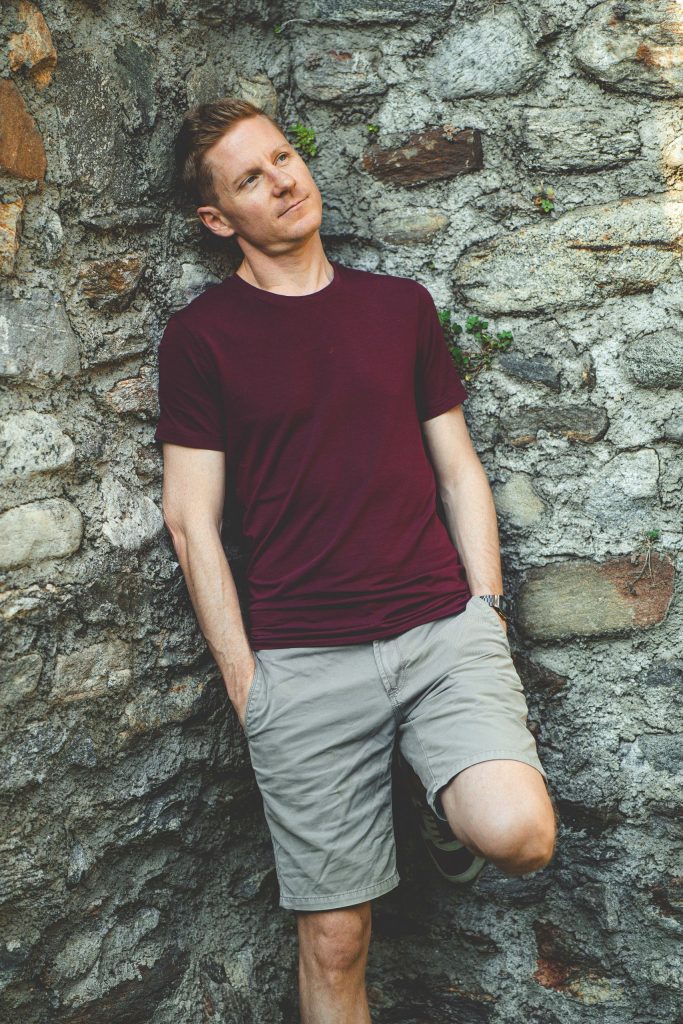 A man leans against the wall, thinking at Castel Grande in Bellinzona
