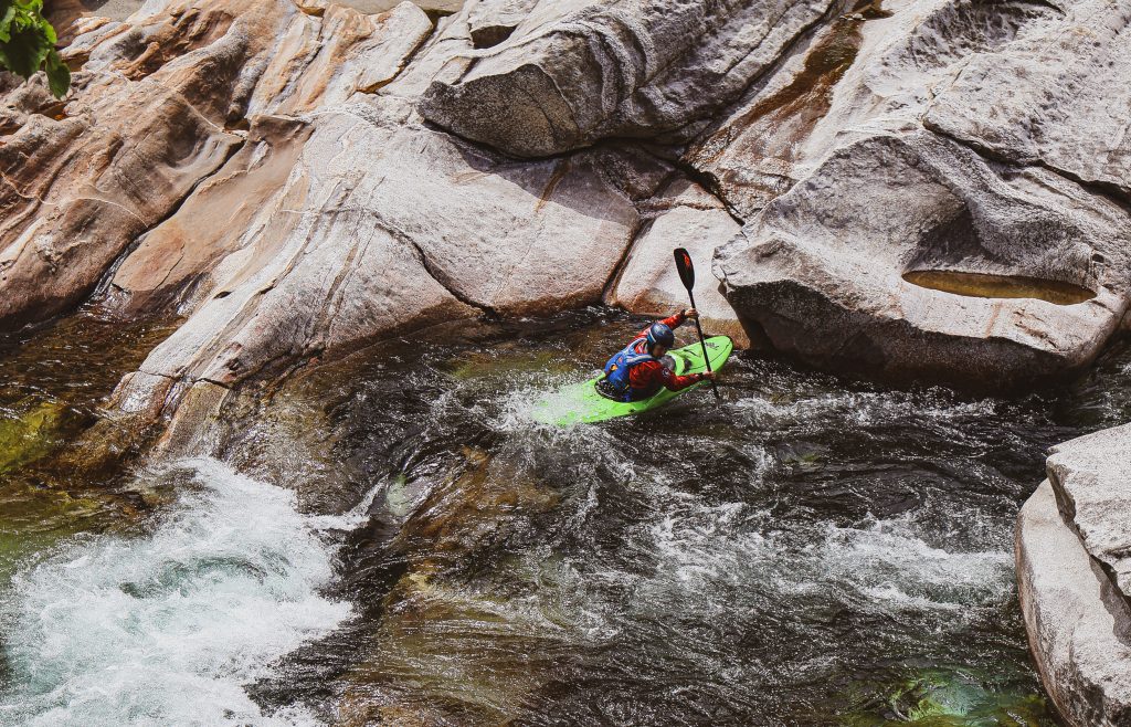A man is rafting down a river in Ticino, Switzerland