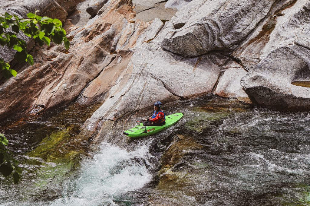 A man is rafting down a river in Ticino, Switzerland