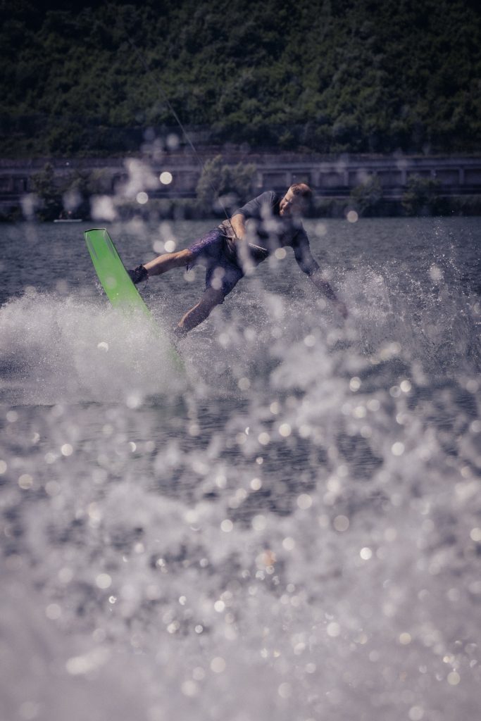 A man is wakeboarding on Lago di Lugano