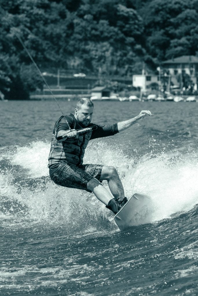 A man is wakeboarding on Lago di Lugano