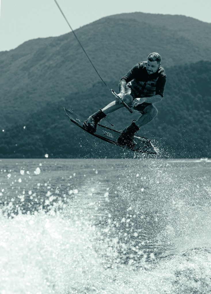 A man is wakeboarding on Lago di Lugano