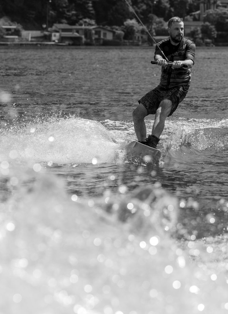 A man is wakeboarding on Lago di Lugano