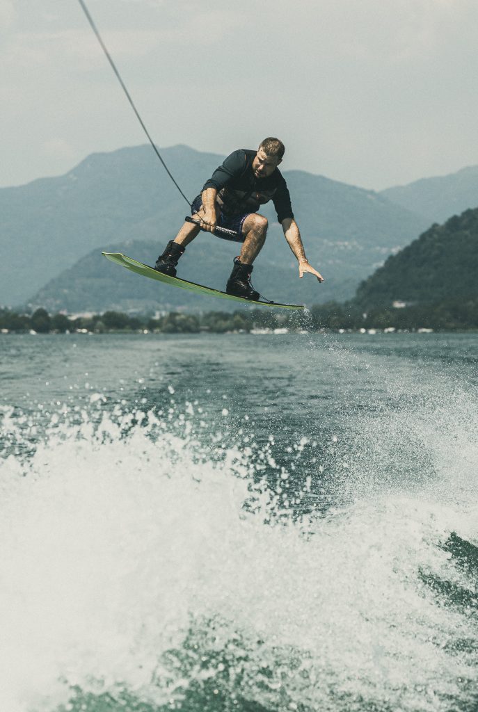 A man is wakeboarding on Lago di Lugano
