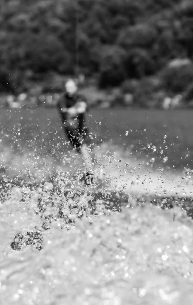 A man is wakeboarding on Lago di Lugano