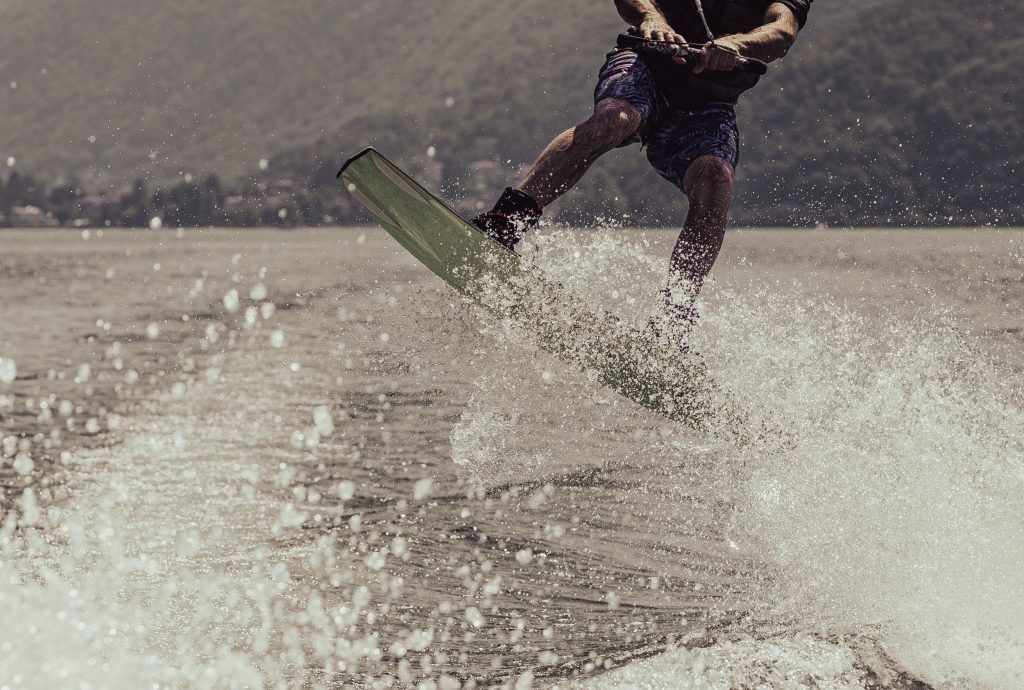 A man is wakeboarding on Lago di Lugano