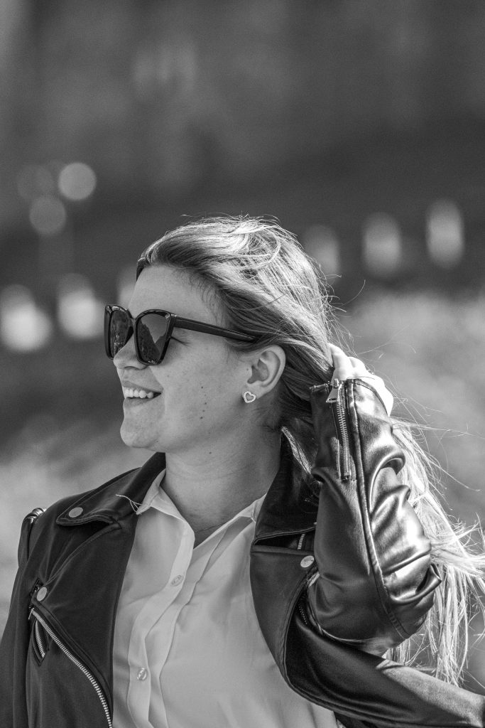 A woman touches her hair at Castel Grande in Bellinzona, laughing