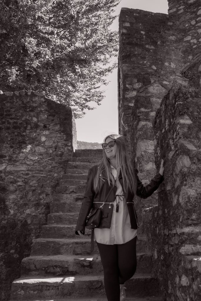A woman walks down the stairs at Castel Grande in Bellinzona, laughing