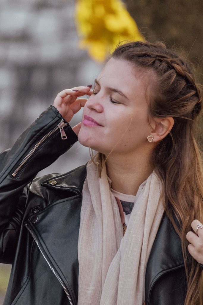 A woman touches her hair with her eyes closed at Lago di Como