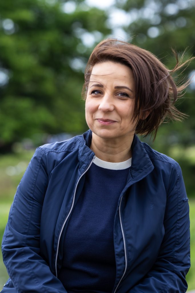 A woman smiles at the camera in London